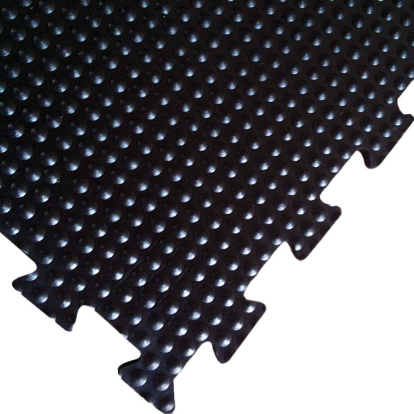 Interlocking rubber tile matt|amoebic top stable mat underside|close up of a bubble top stable mat