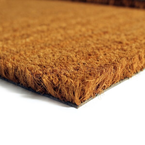 Close-up of the corner of a Weather Resistant Entrance Mat, highlighting its rough, fibrous texture and brown colour against a white background.