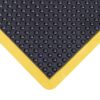 Close-up of the Interlocking Air Cushioned Mat in black rubber, featuring raised circular bumps and a yellow border at the corner.