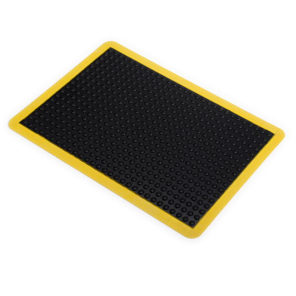 The Air Cushioned Workshop Mat is a rectangular black rubber mat with a textured, raised dot surface and a yellow border, shown on a white background.