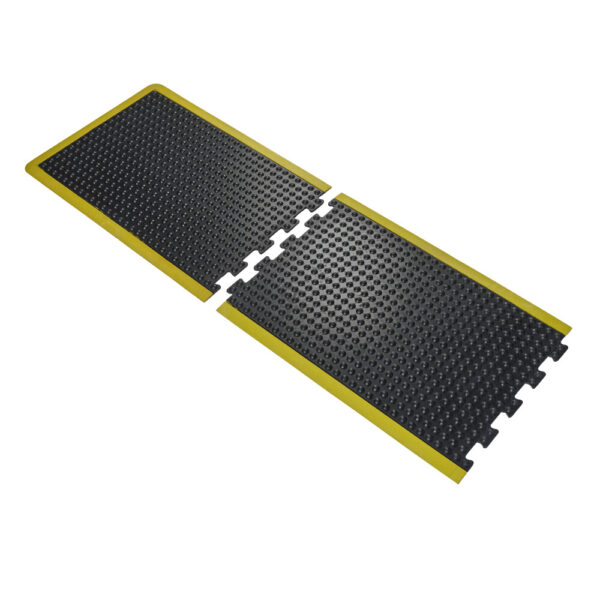 Two Interlocking Air Cushioned Mats with black rubber surfaces, yellow borders, raised bumps for grip, and puzzle-like edges are joined together side by side.