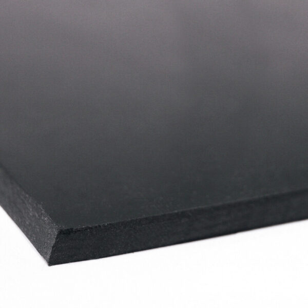 A close-up of Black Commercial Rubber, featuring smooth surfaces and straight edges, displayed on a white background.