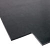 A close-up of Black Commercial Rubber, a flat black sheet with a rectangular notch cut from one edge, displayed against a white background.