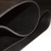 A close-up of Black Commercial Rubber partially rolled, highlighting its smooth, flexible texture and clean edges.