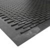 A close-up of the Scraper Entrance Mat shows its black rubber surface with a textured, interlocking pattern designed to enhance grip and minimise slipping.