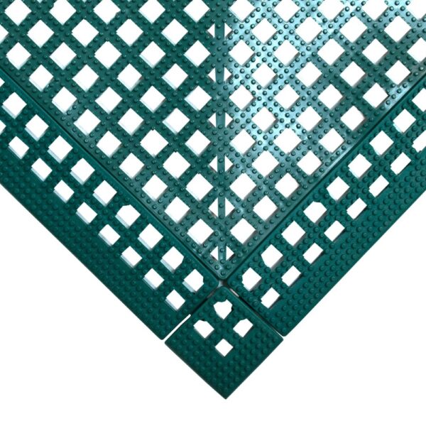 The Interlocking Anti-Slip Leisure Tile features green plastic construction with a square grid pattern, raised bumps, and perforated square holes for drainage or ventilation. Shown forming a right-angle corner.