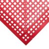 Close-up view of a red Interlocking Anti-Slip Leisure Tile, featuring a grid of square holes at a right-angle corner. The tile’s surface is textured with small raised dots for added slip resistance.