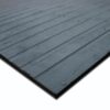 Close-up view of the Heavy-Duty Gym Mat, a black rectangular rubber mat featuring a ribbed texture and circular markings, laid flat on a white background.
