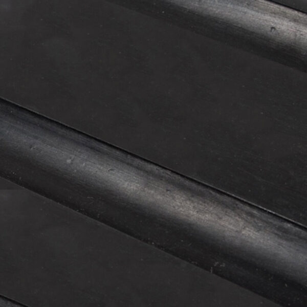 Close-up of the Heavy-Duty Gym Mat’s smooth black surface, featuring diagonal parallel raised grooves for enhanced grip.