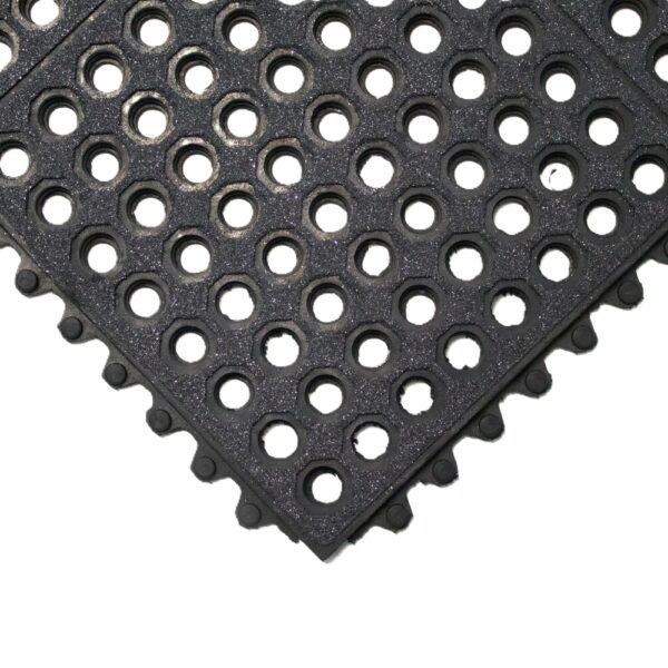 A close-up of the Nitrile Top Interlocking Mat, a black rubber mat featuring evenly spaced circular holes and interlocking edges for modular assembly.