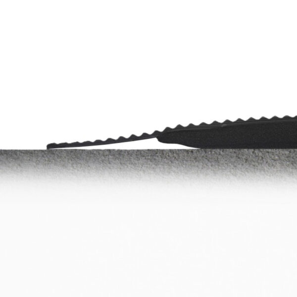 A serrated black knife blade is shown in close-up, positioned horizontally and partially cutting into the surface of a Diamond Welding Mat in light grey against a white background.