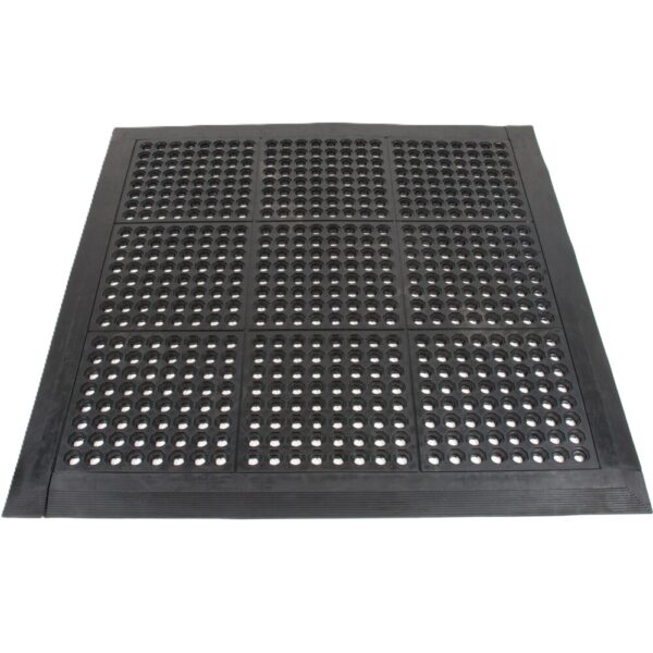 The Drainage Top Interlocking Mat is a black rubber anti-fatigue mat with bevelled edges and a grid of round holes, designed for industrial or commercial use.